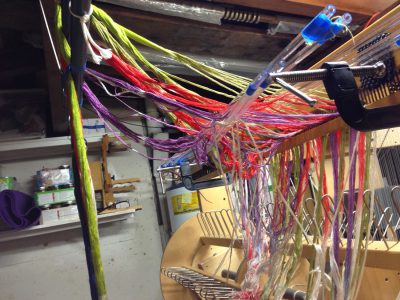 a tangle of warp dangling over a trapeze