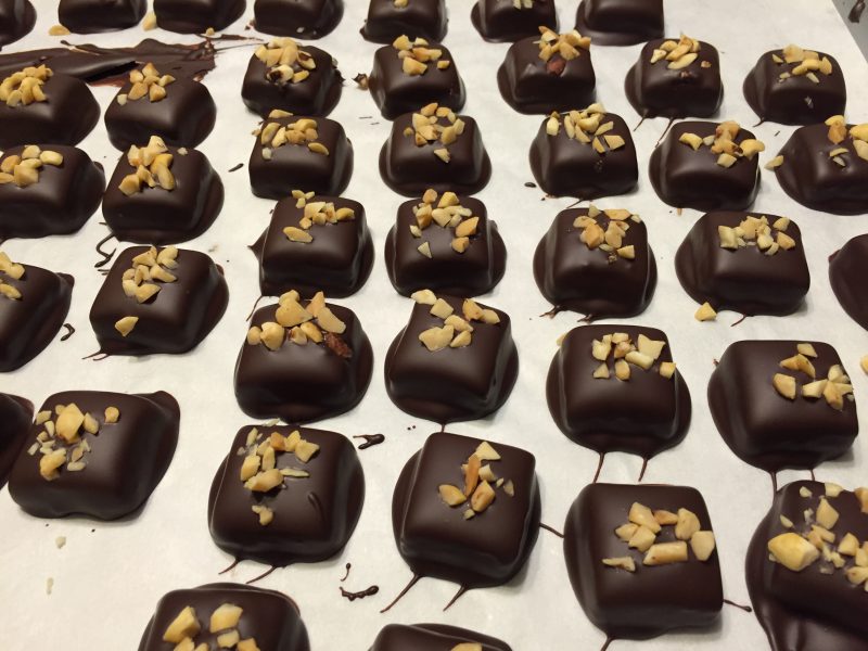 Ginger lime chili caramels covered in chocolate and sprinkled with chopped peanuts